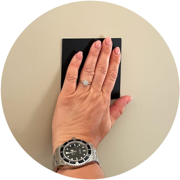Take the frame off the wall and press the Custtom<sup>®</sup> magnet firmly.